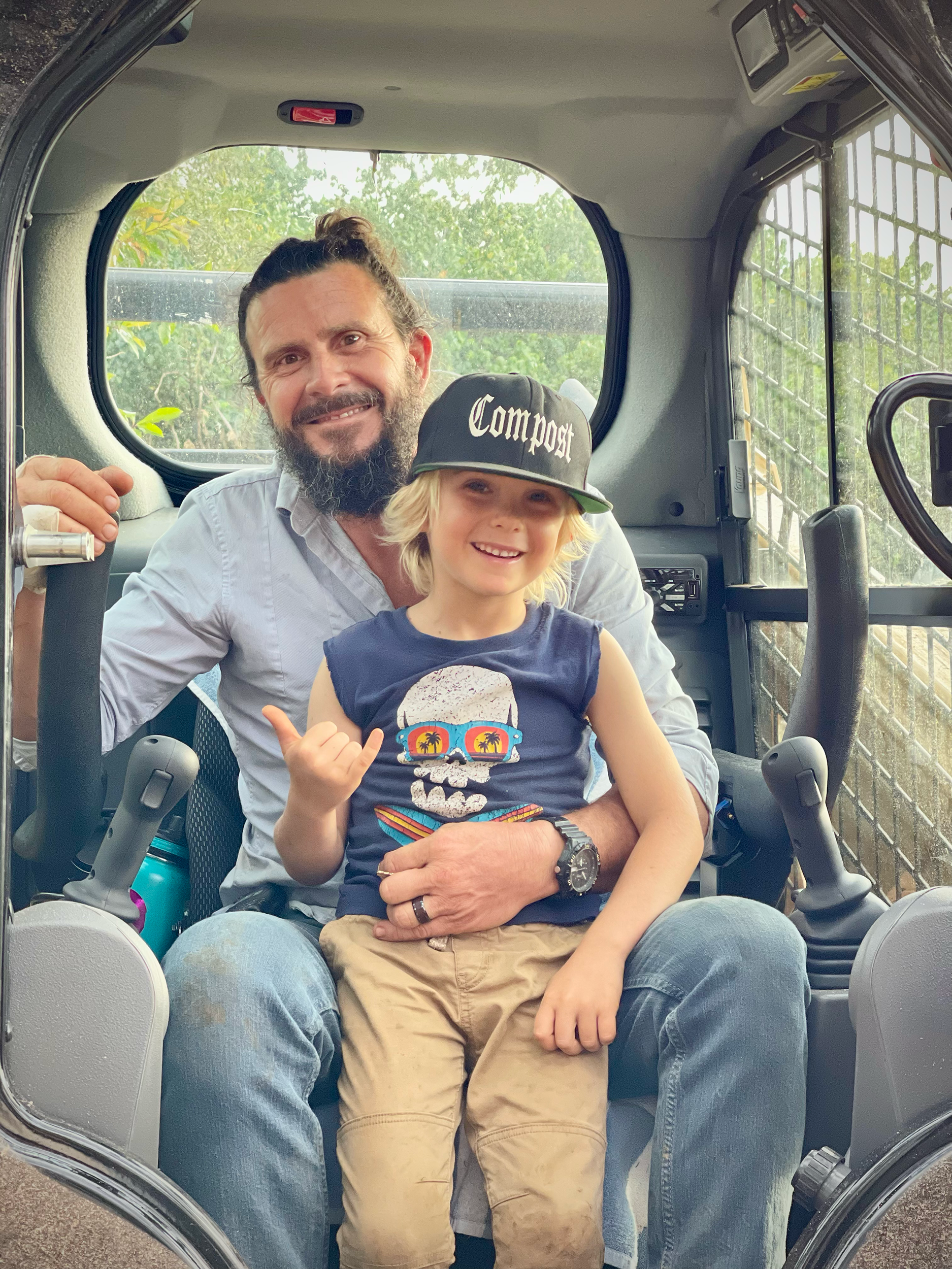 Alain and his son in the tractor cab — Maui Landworks